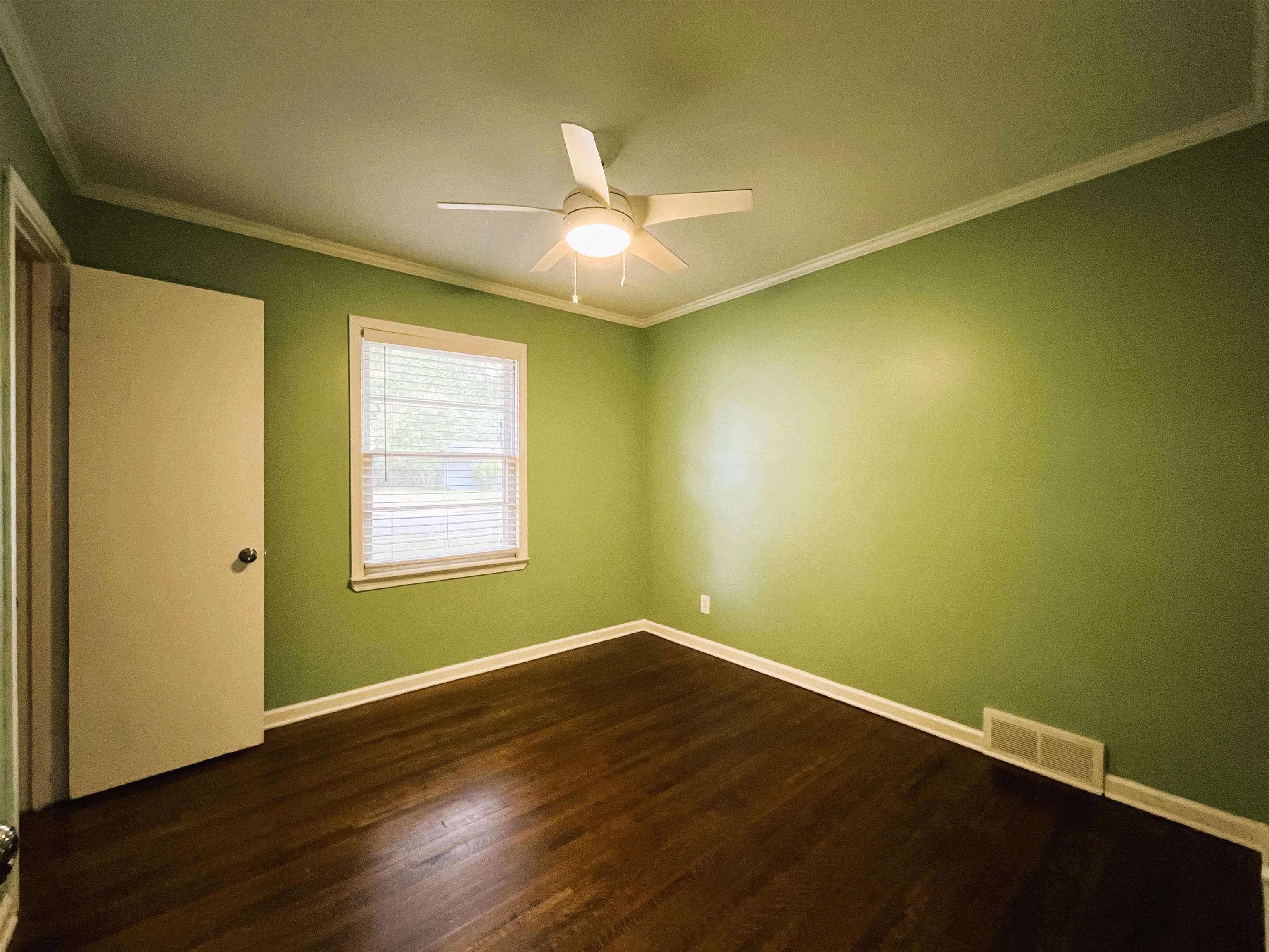 1570 Dearing Road Memphis, TN 38117 - Photo 10 of 16 Unfurnished room featuring dark wood finished floors, crown molding, and ceiling fan