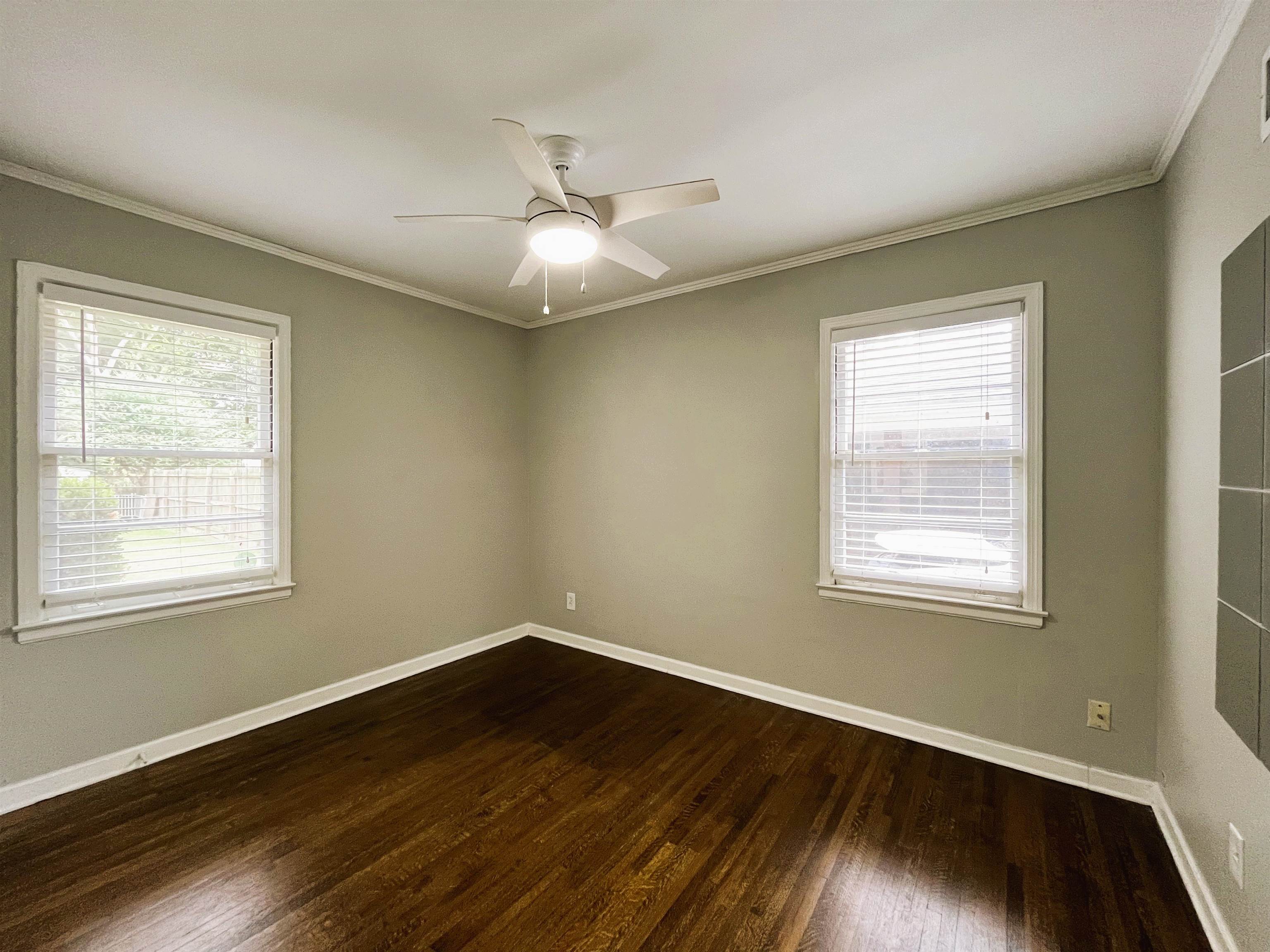 1570 Dearing Road Memphis, TN 38117 - Photo 14 of 16 Spare room featuring dark wood-style flooring, ornamental molding, and ceiling fan