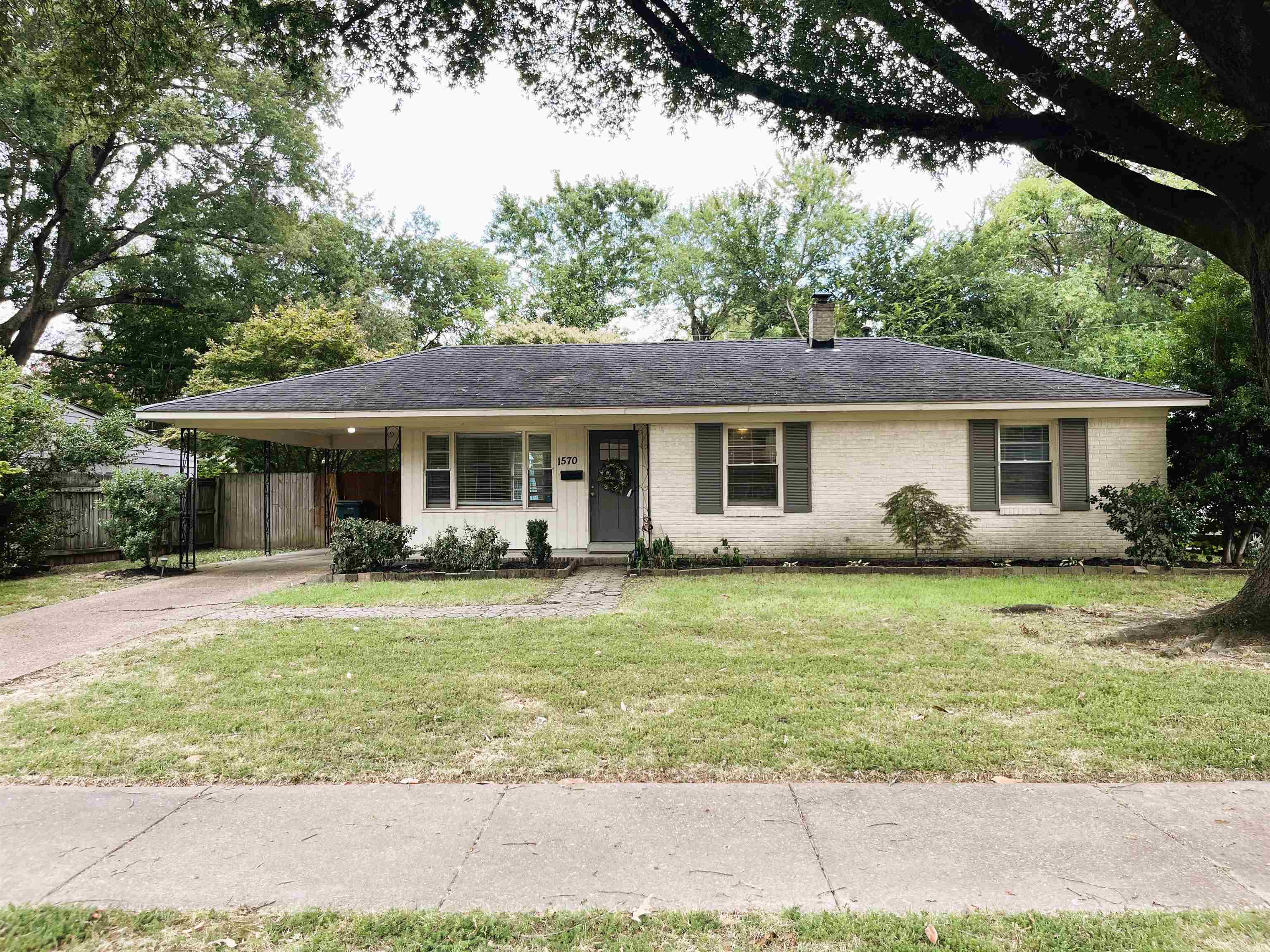 1570 Dearing Road Memphis, TN 38117 - Photo 2 of 16 Single story home featuring a porch, a chimney, brick siding, driveway, and roof with shingles