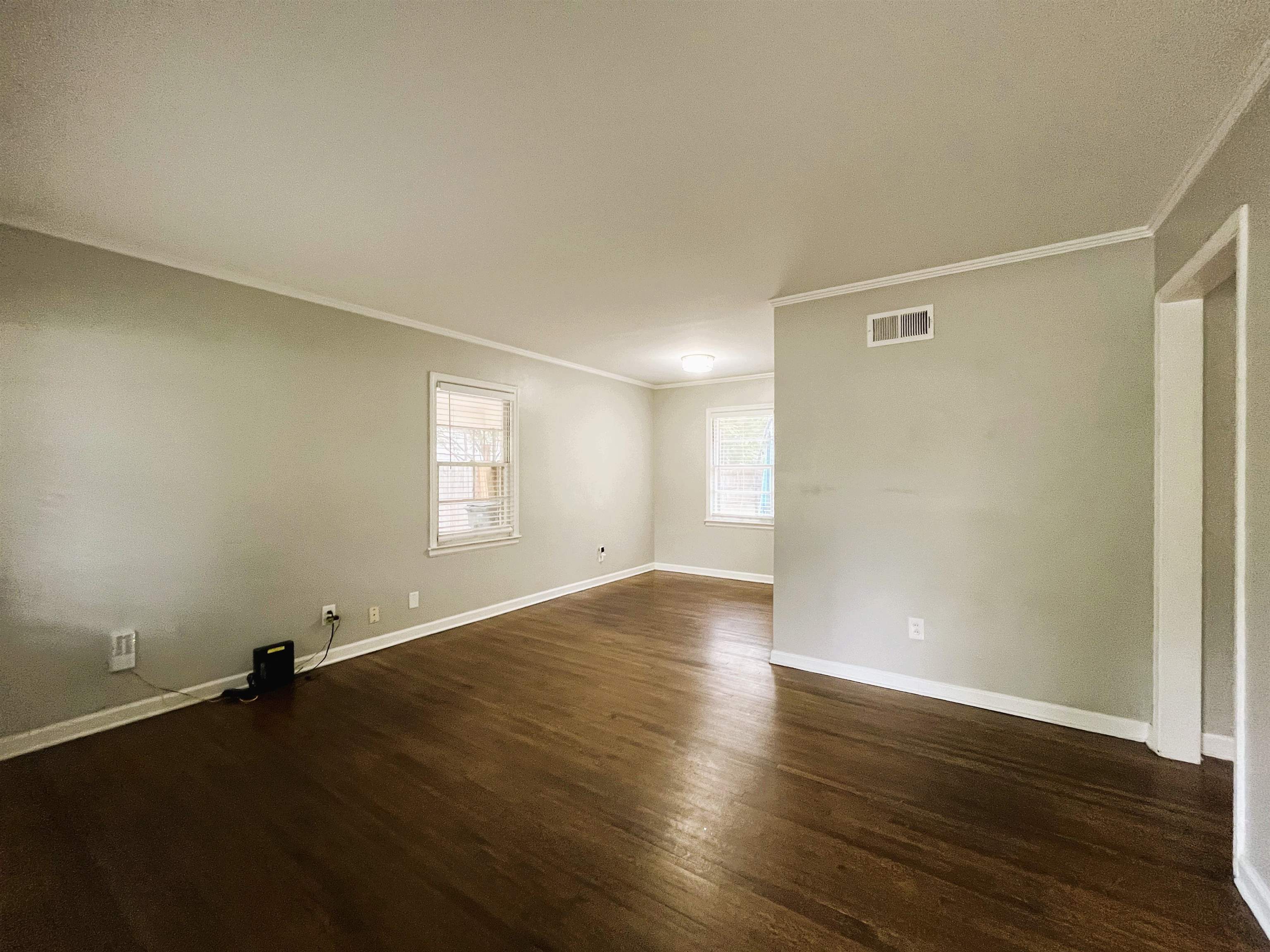 1570 Dearing Road Memphis, TN 38117 - Photo 3 of 16 Spare room featuring crown molding and dark wood finished floors