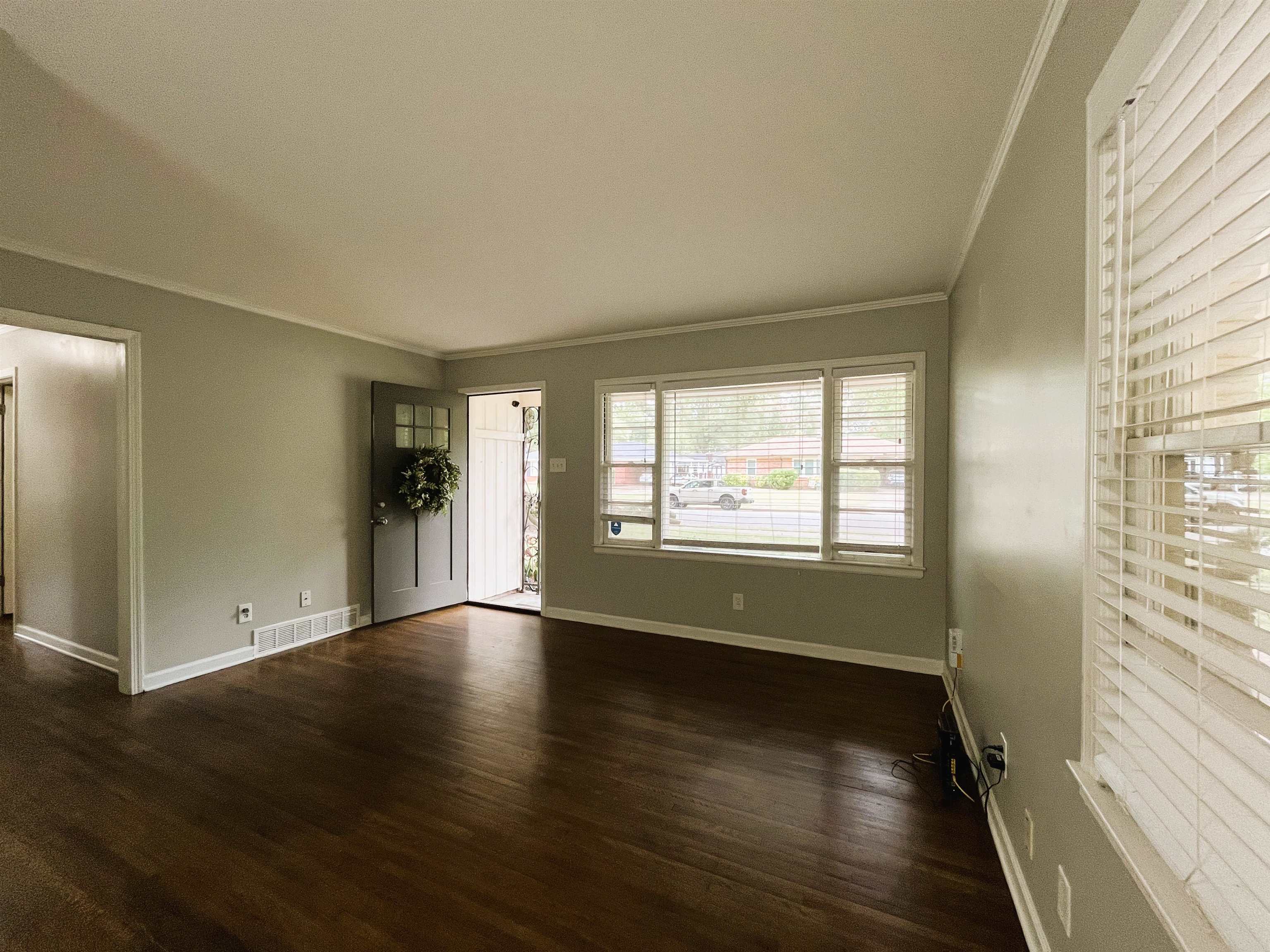 1570 Dearing Road Memphis, TN 38117 - Photo 4 of 16 Unfurnished living room featuring ornamental molding and dark wood-type flooring
