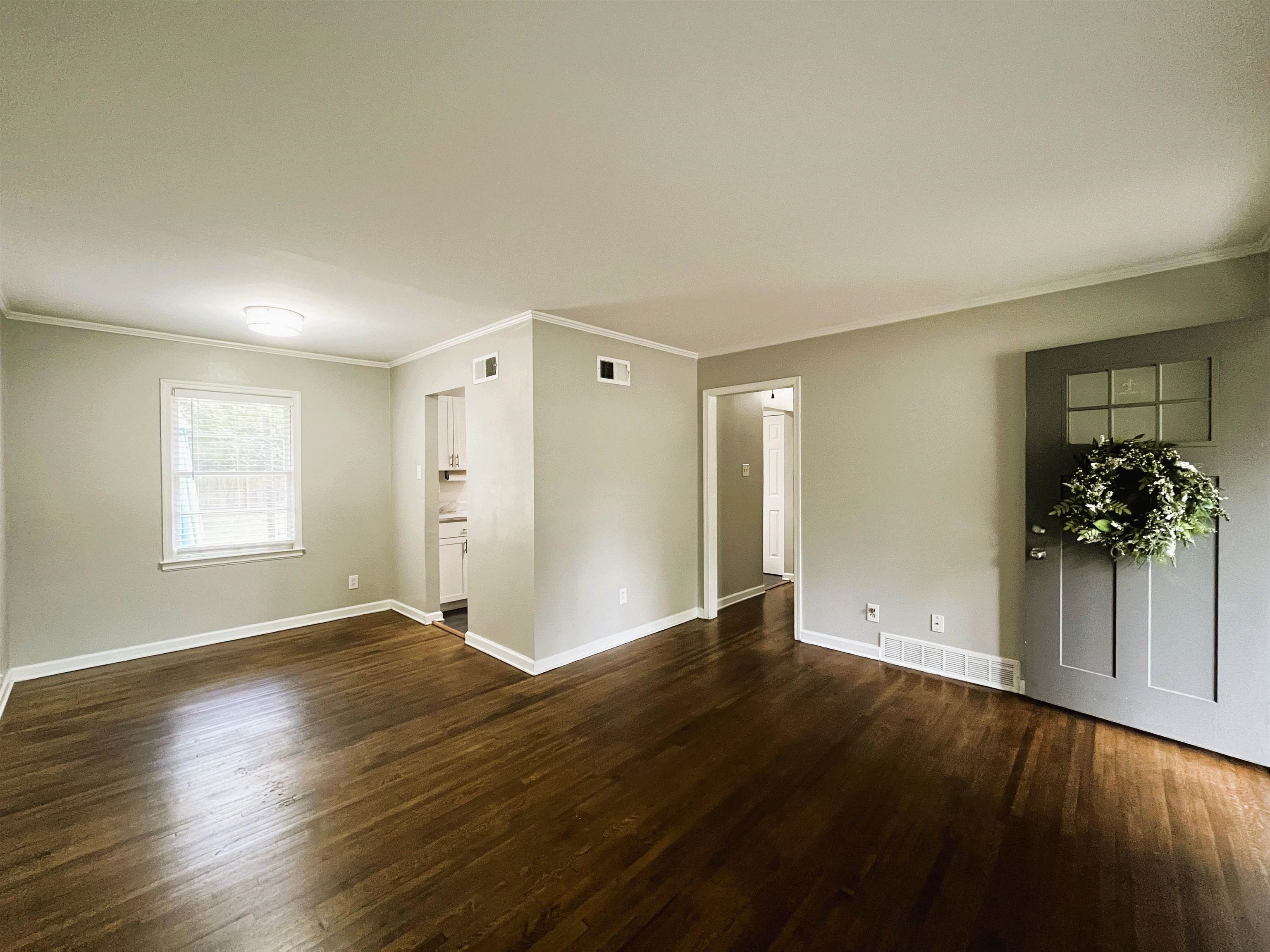 1570 Dearing Road Memphis, TN 38117 - Photo 5 of 16 Spare room with crown molding and dark wood finished floors