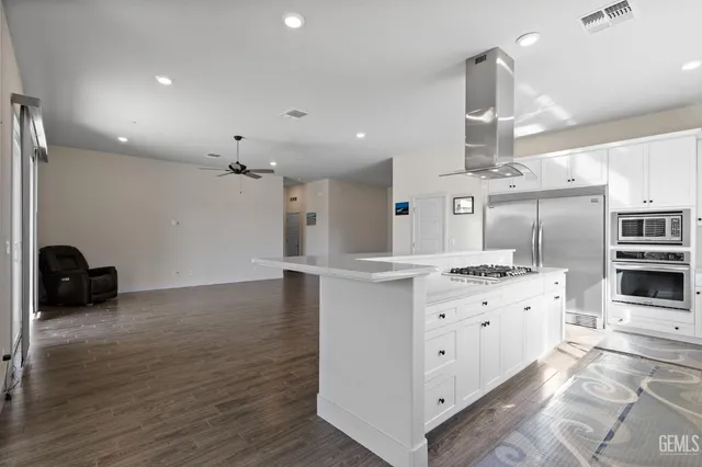a kitchen with granite countertop a sink and a stove top oven