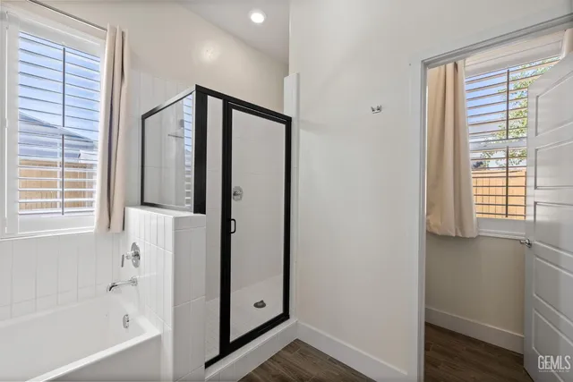 a bathroom with a bathtub and a shower