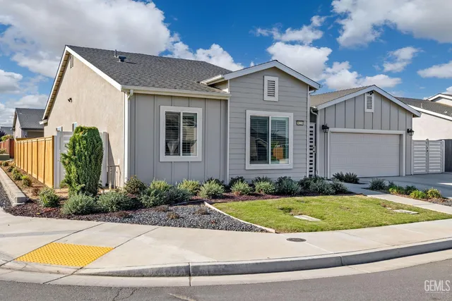 a view of a house with swimming pool and sitting area