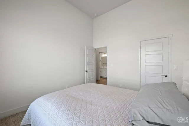 a bedroom with a bed and a bathroom