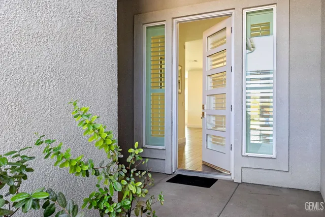 a front view of a house with a potted plant