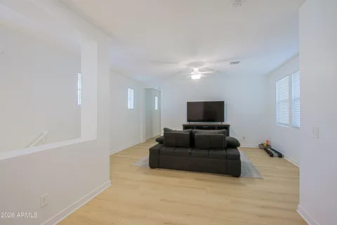 a bedroom with a bed and a flat tv screen on dresser