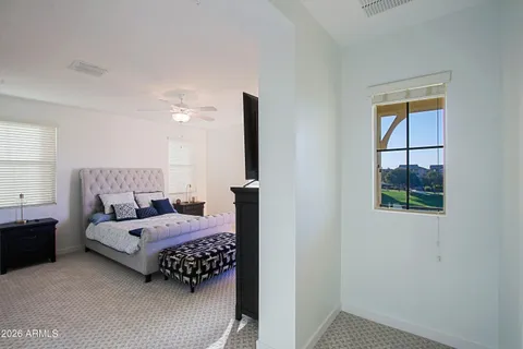 a bedroom with a bed and a chandelier