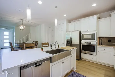 a kitchen with a refrigerator stove and cabinets