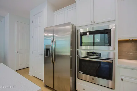 a kitchen with a table chairs and a refrigerator
