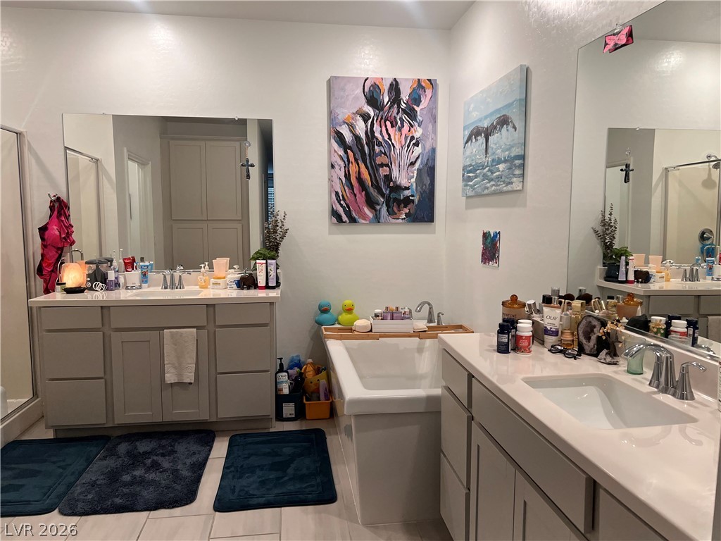 2555 Hampton Road, Unit 2207 Henderson, NV 89052 - Photo 28 of 34 Dual vanities and a deep soaking tub create a luxurious primary bath retreat.