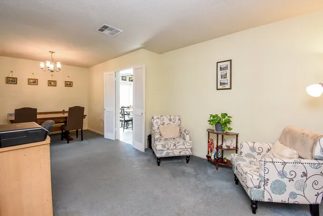 a view of a bedroom with furniture and windows