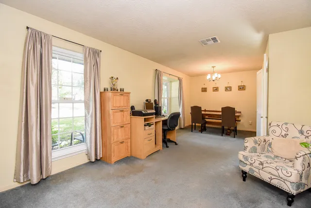 a work room with furniture and a window