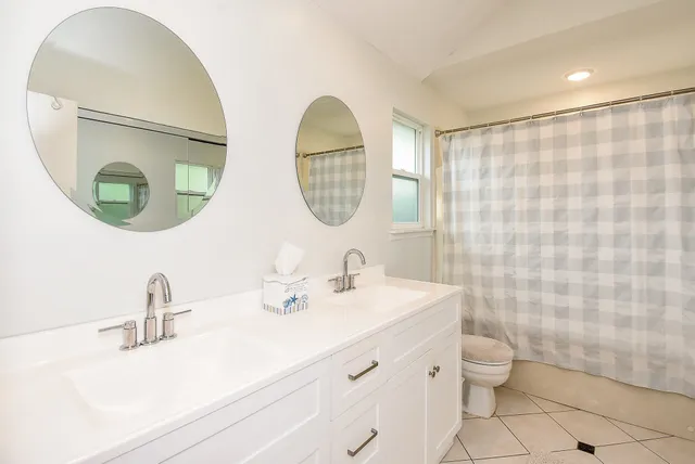 a bedroom with a large bed and a lamp