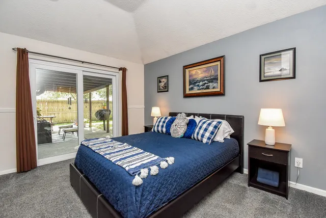 a bed room with a bed and a television