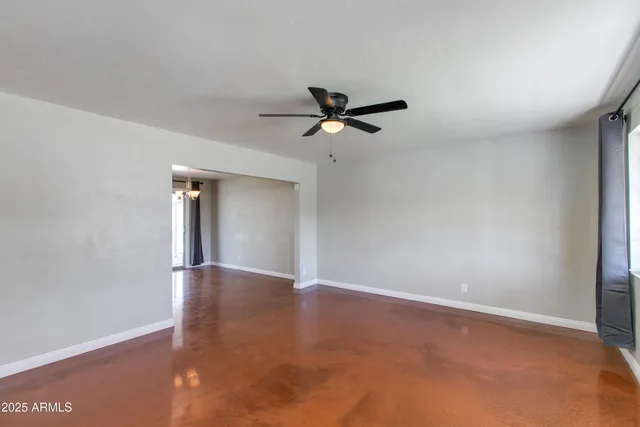 a view of room with window and a ceiling fan