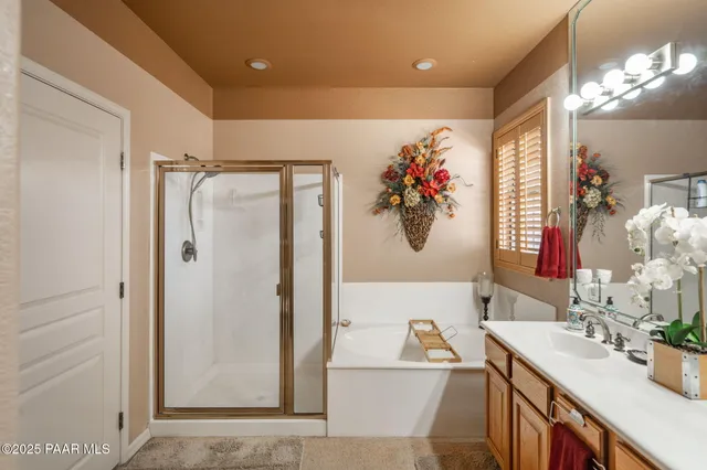 a bathroom with a tub a sink and a shower