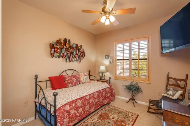 a bedroom with a bed and a painting on the wall