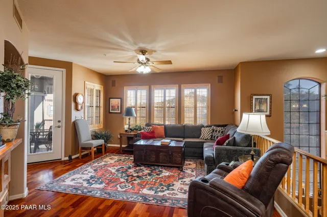 a living room with furniture ceiling fan and a rug