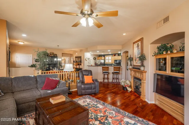 a living room with furniture and kitchen view