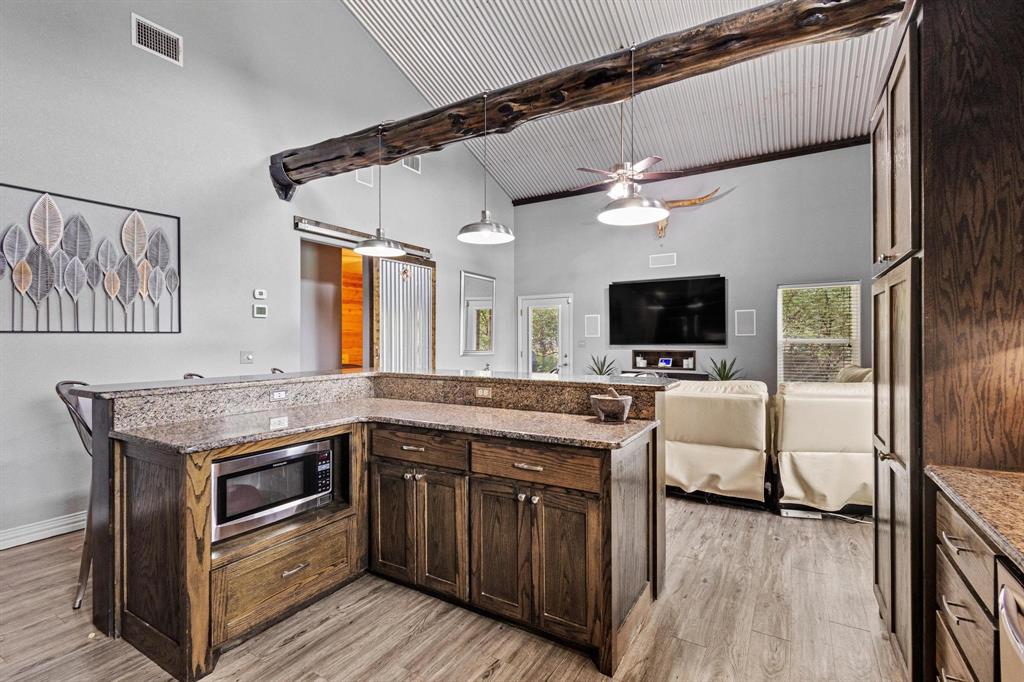 595 Pleasant Home Road Sherman, TX 75092 - Photo 12 of 40 a kitchen with a stove and a microwave