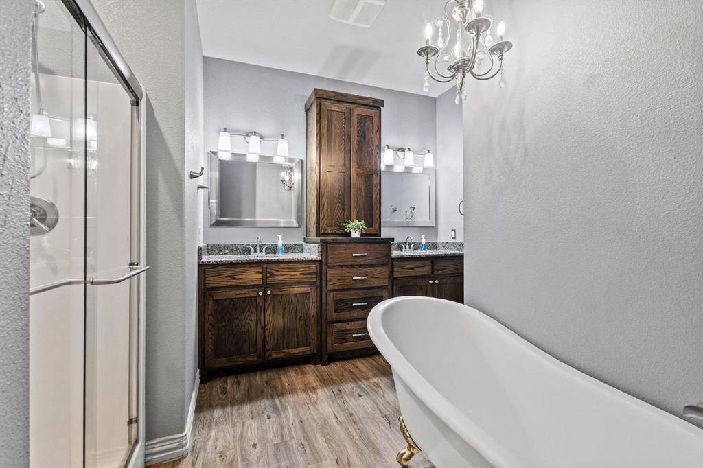 595 Pleasant Home Road Sherman, TX 75092 - Photo 16 of 40 a bathroom with a bathtub shower sink vanity and a mirror