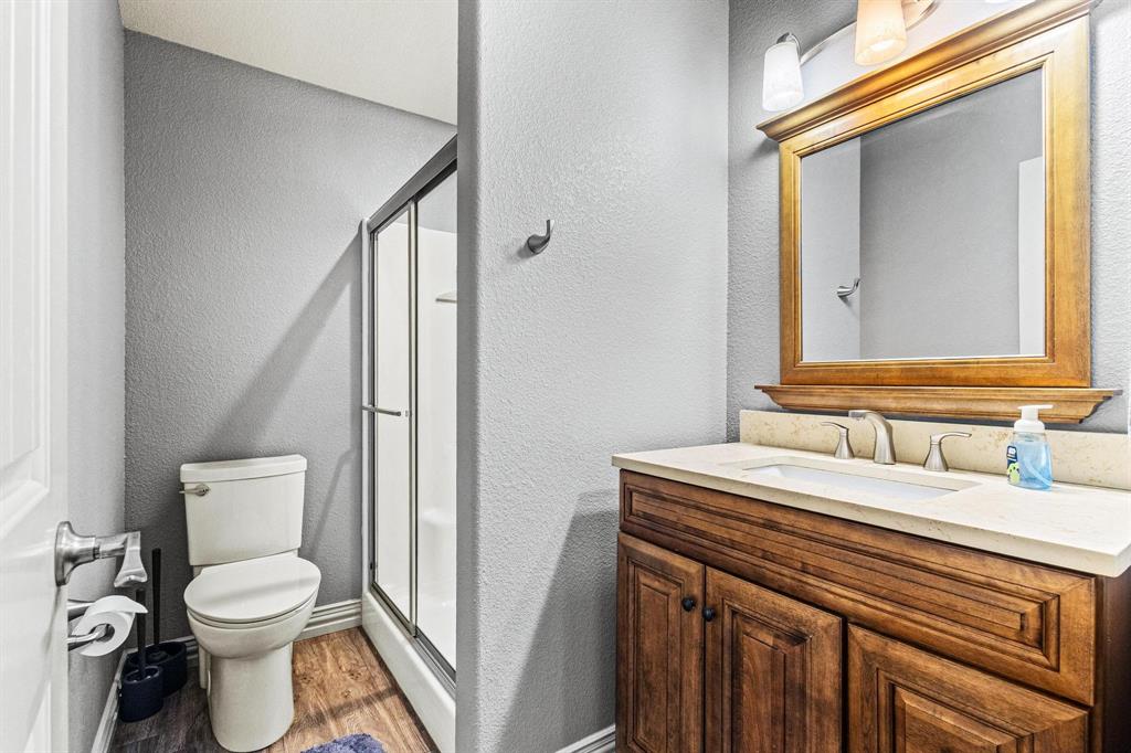 595 Pleasant Home Road Sherman, TX 75092 - Photo 20 of 40 a bathroom with a toilet sink and mirror