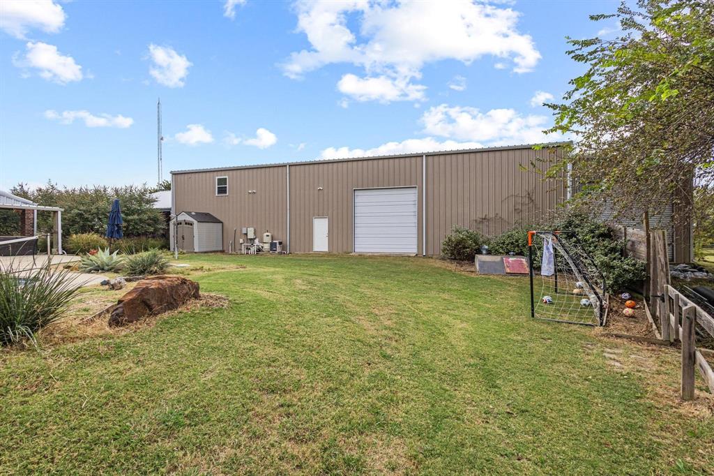 595 Pleasant Home Road Sherman, TX 75092 - Photo 29 of 40 a backyard of a house with table and chairs