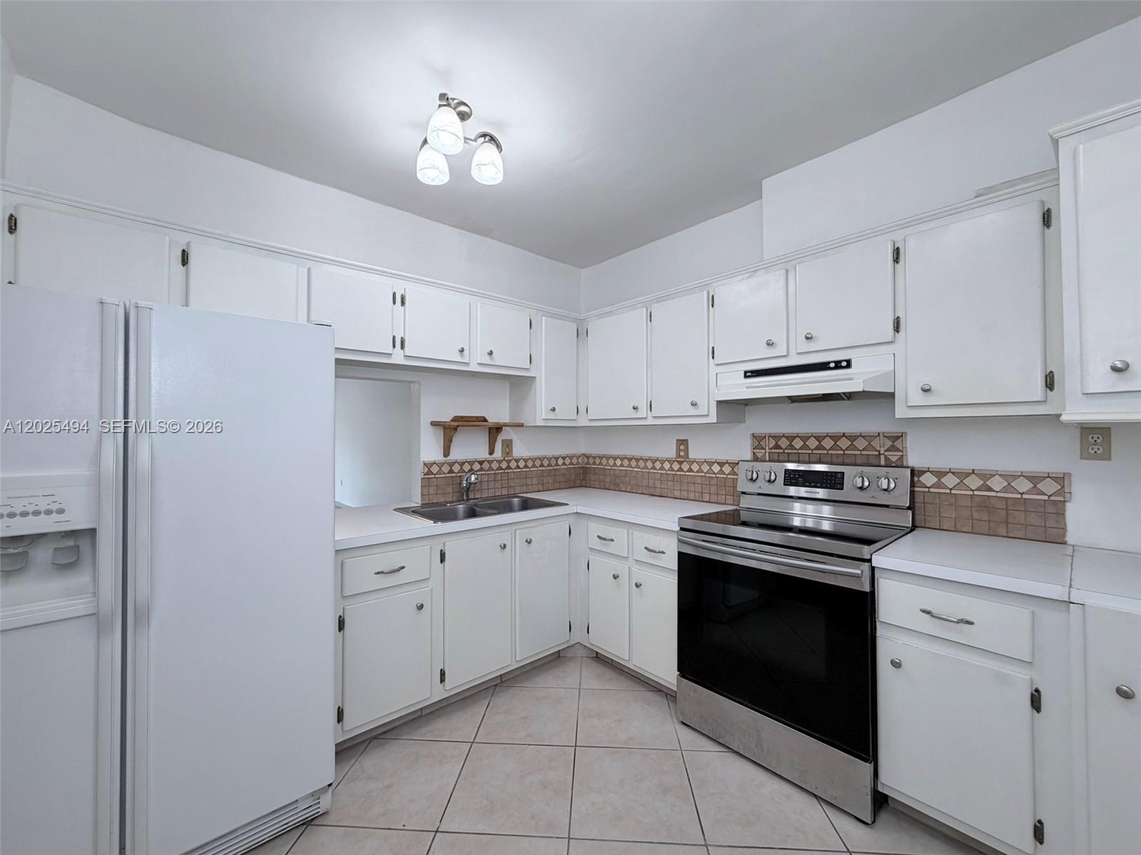 9159 Southwest 77th Avenue, Unit 112 Miami, FL 33156 - Photo 10 of 38 a kitchen with cabinets appliances and a sink