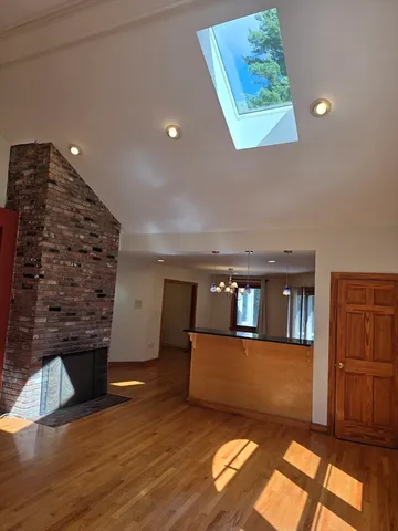 a view of a living room with furniture and a fireplace