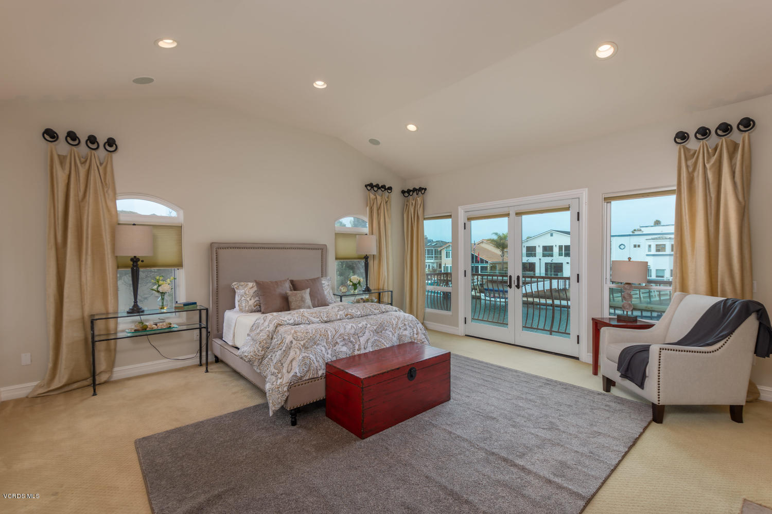 2301 Peninsula Road Oxnard, CA 93035 - Photo 12 of 37 a spacious bedroom with a bed and glass door