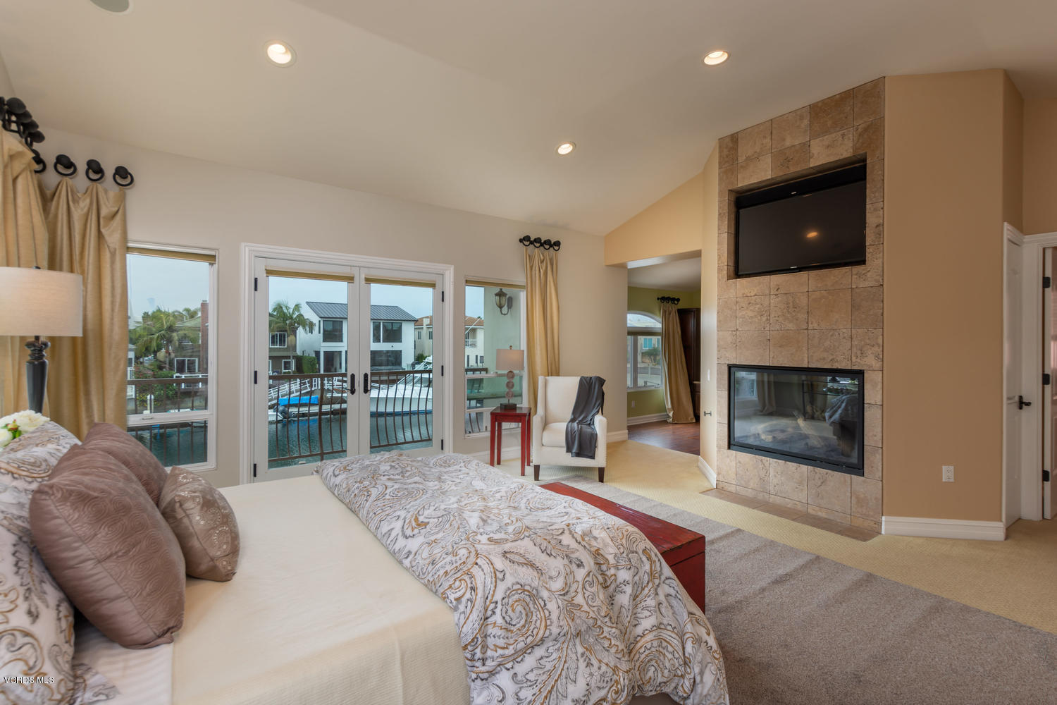 2301 Peninsula Road Oxnard, CA 93035 - Photo 13 of 37 a bedroom with a bed and a fireplace