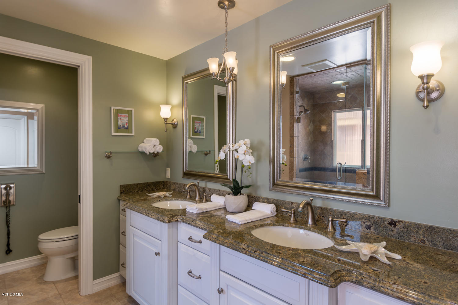 2301 Peninsula Road Oxnard, CA 93035 - Photo 17 of 37 a bathroom with a granite countertop sink toilet and mirror