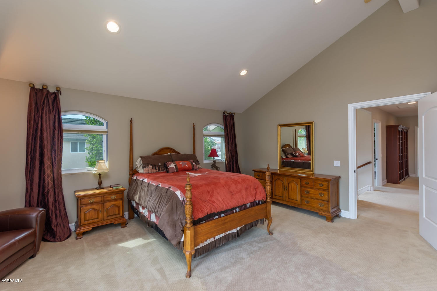 2301 Peninsula Road Oxnard, CA 93035 - Photo 19 of 37 a spacious bedroom with a bed and a chandelier