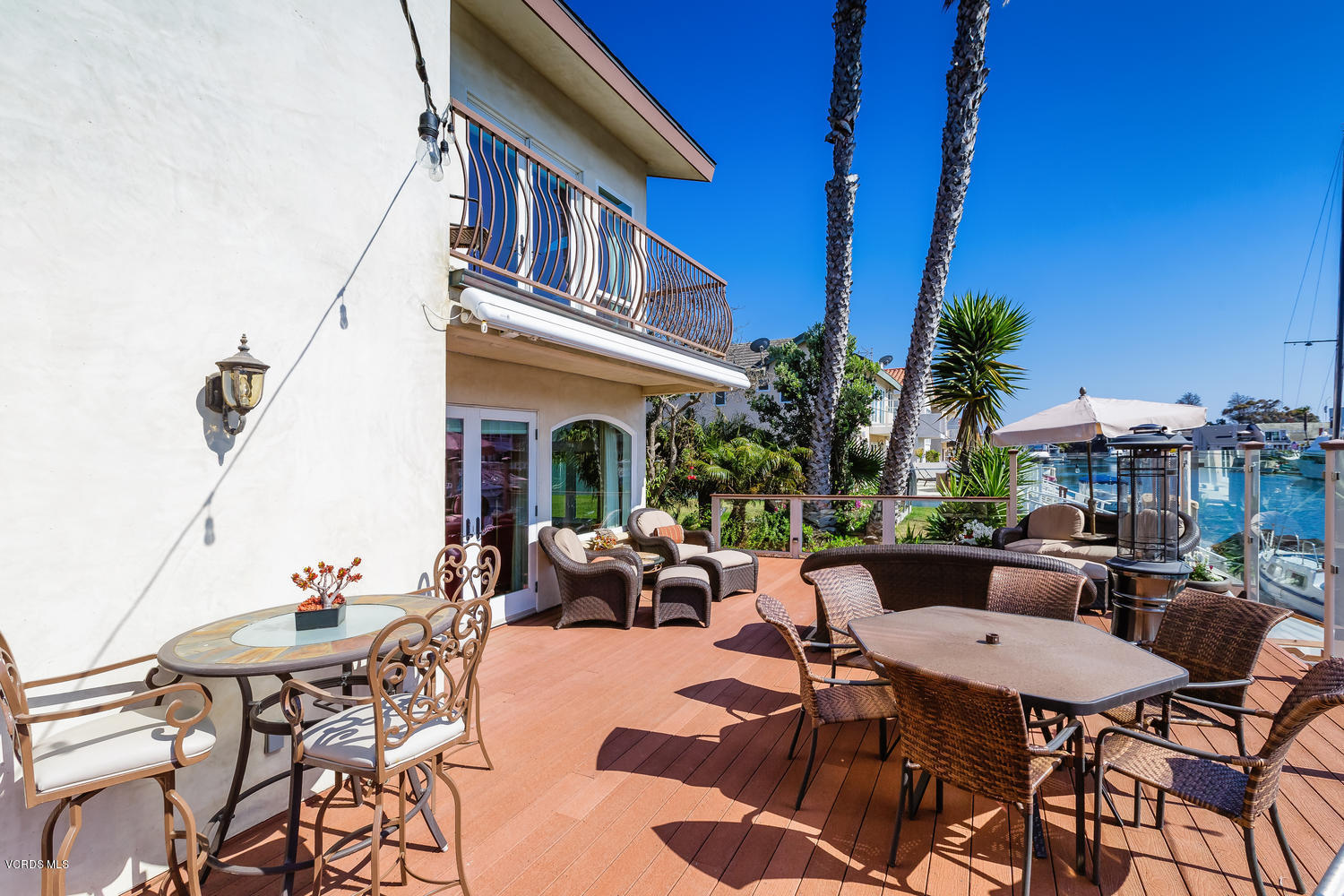 2301 Peninsula Road Oxnard, CA 93035 - Photo 28 of 37 a view of a patio with couches and table and chairs with potted plants