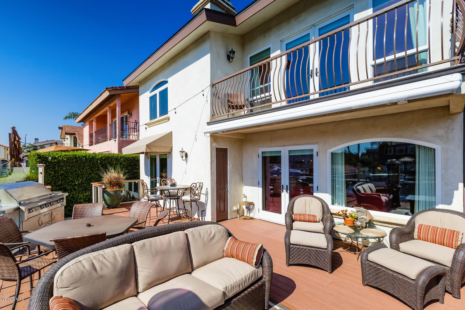 2301 Peninsula Road Oxnard, CA 93035 - Photo 31 of 37 a view of a patio with couches table and chairs with potted plants and palm trees