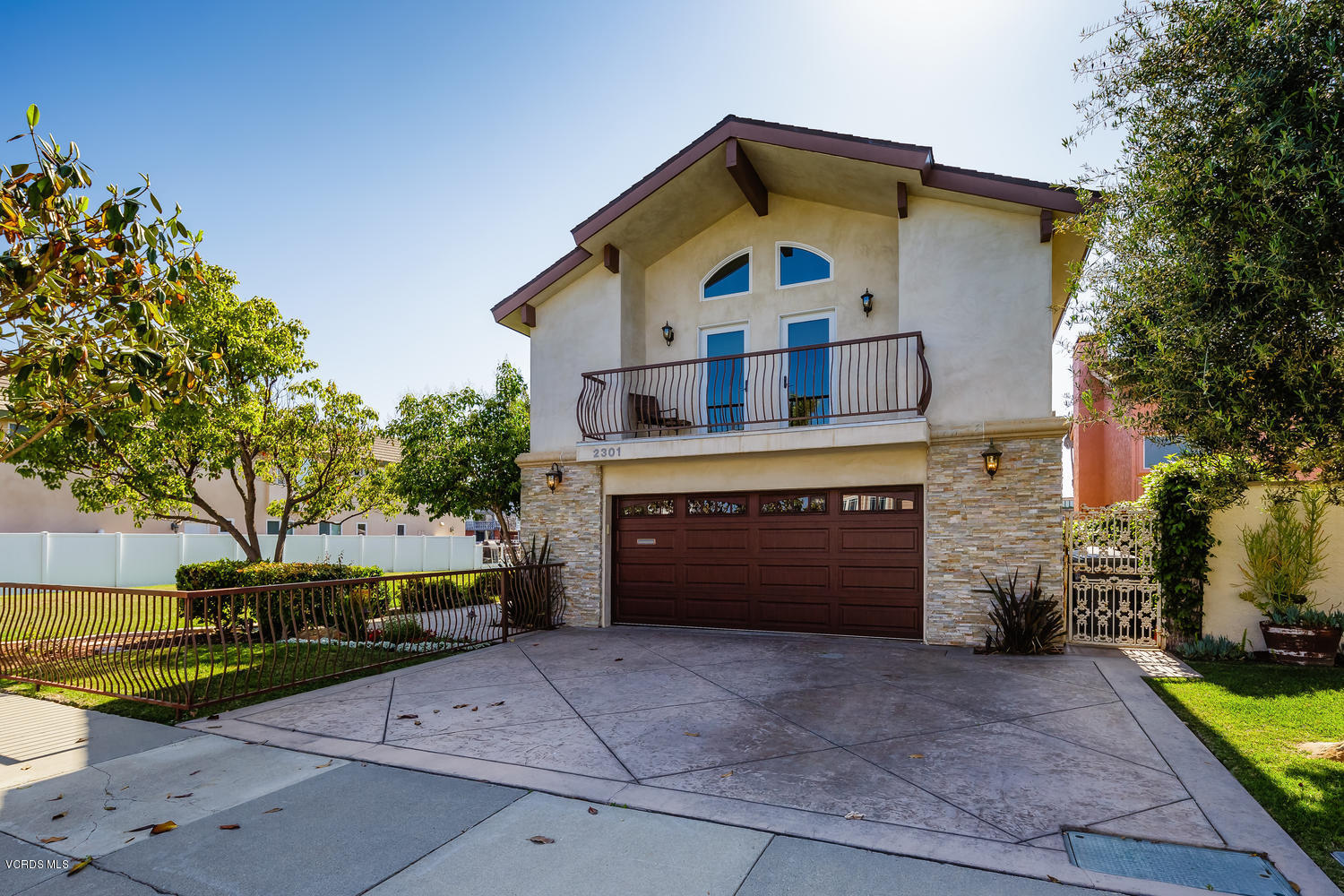 2301 Peninsula Road Oxnard, CA 93035 - Photo 33 of 37 a front view of a house with a yard and garage