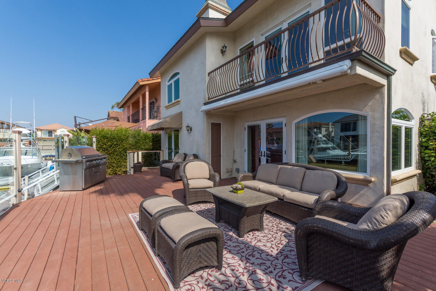 2301 Peninsula Road Oxnard, CA 93035 - Photo 35 of 37 a view of a patio with couches table and chairs with wooden floor