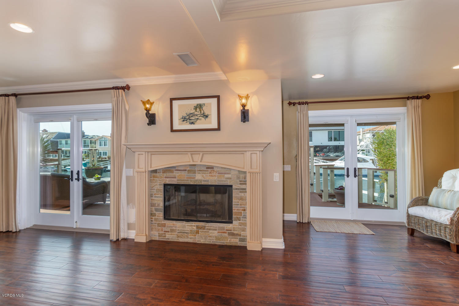 2301 Peninsula Road Oxnard, CA 93035 - Photo 6 of 37 a living room with wooden floor and a fireplace