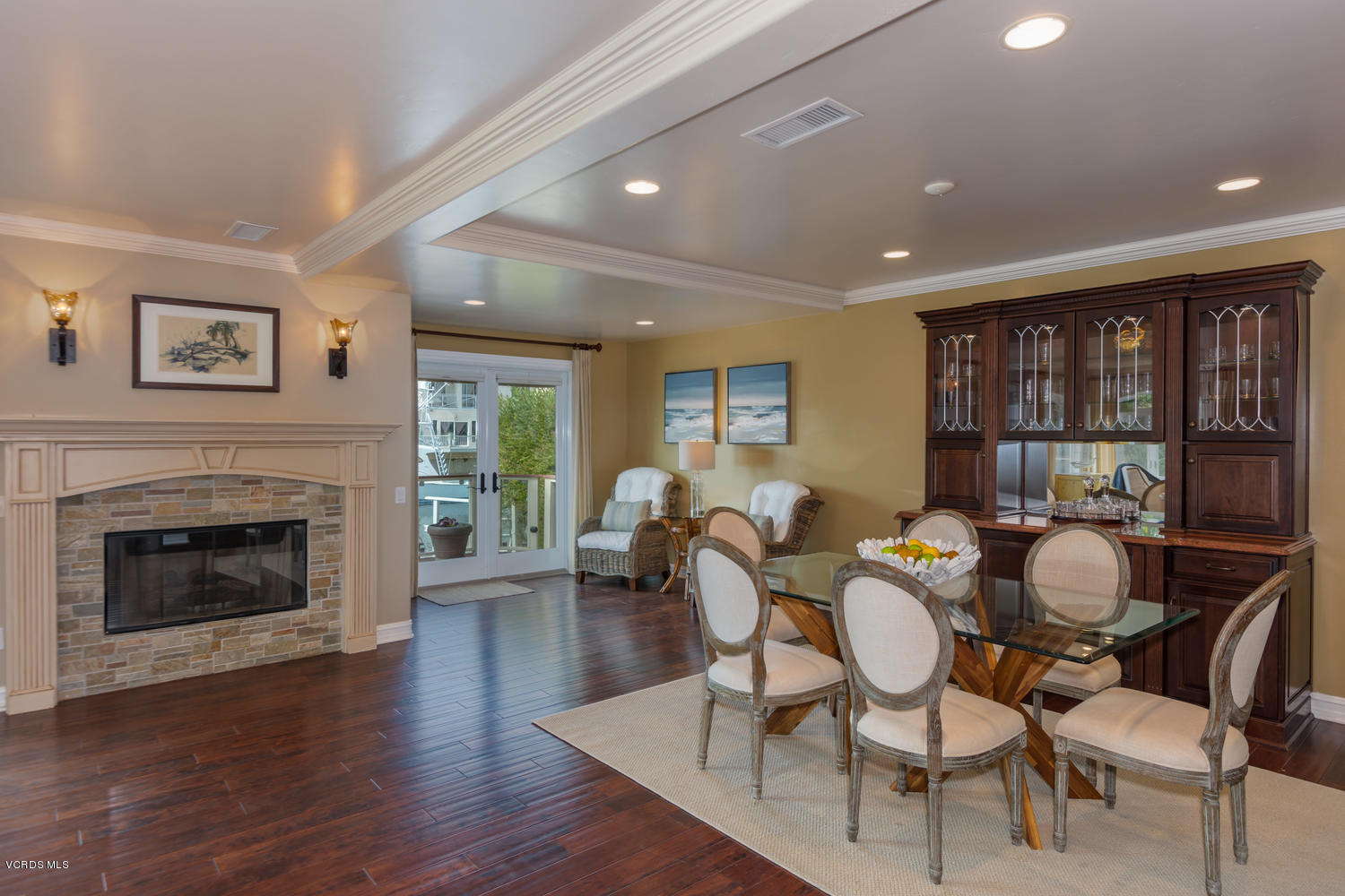 2301 Peninsula Road Oxnard, CA 93035 - Photo 7 of 37 a dining room with furniture a fireplace and wooden floor