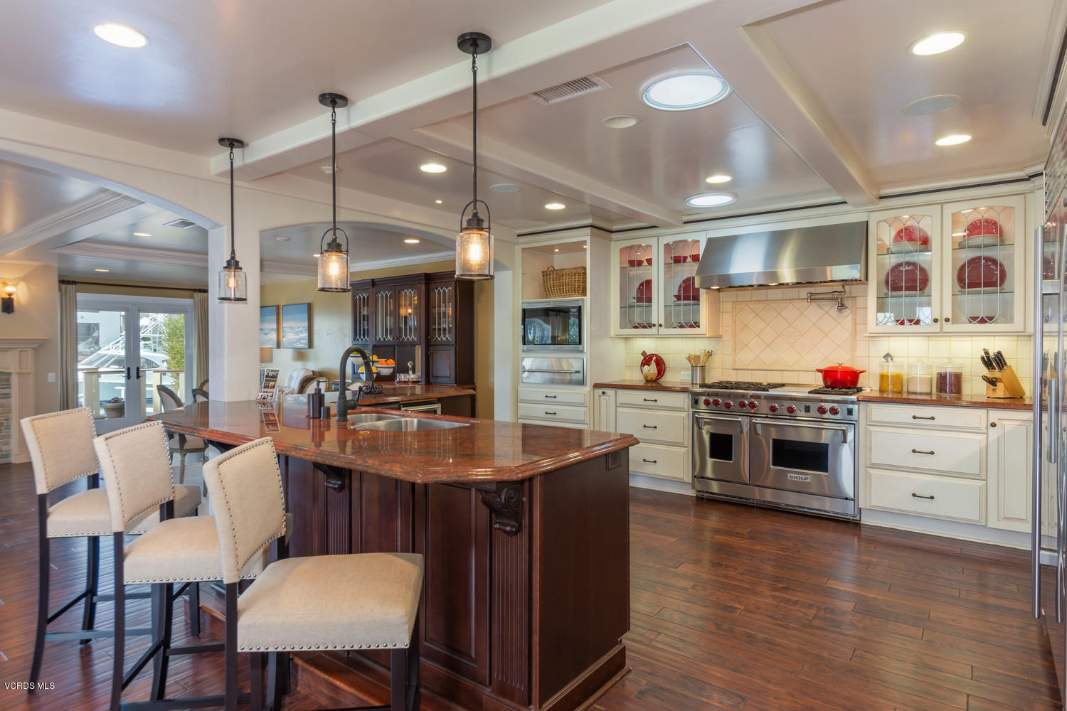 2301 Peninsula Road Oxnard, CA 93035 - Photo 9 of 37 a kitchen with stainless steel appliances a stove a sink dishwasher and a dining table with chairs