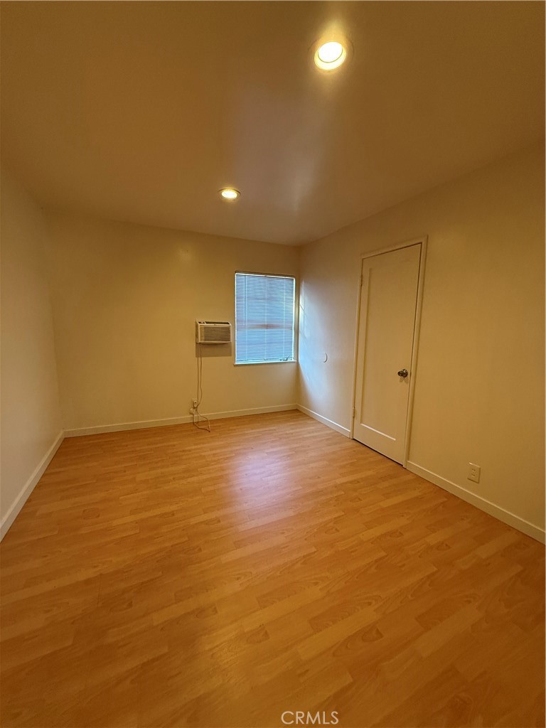981 Barney Street Merced, CA 95340 - Photo 5 of 8 an empty room with wooden floor