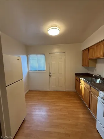 a bathroom with a toilet a sink a mirror and vanity