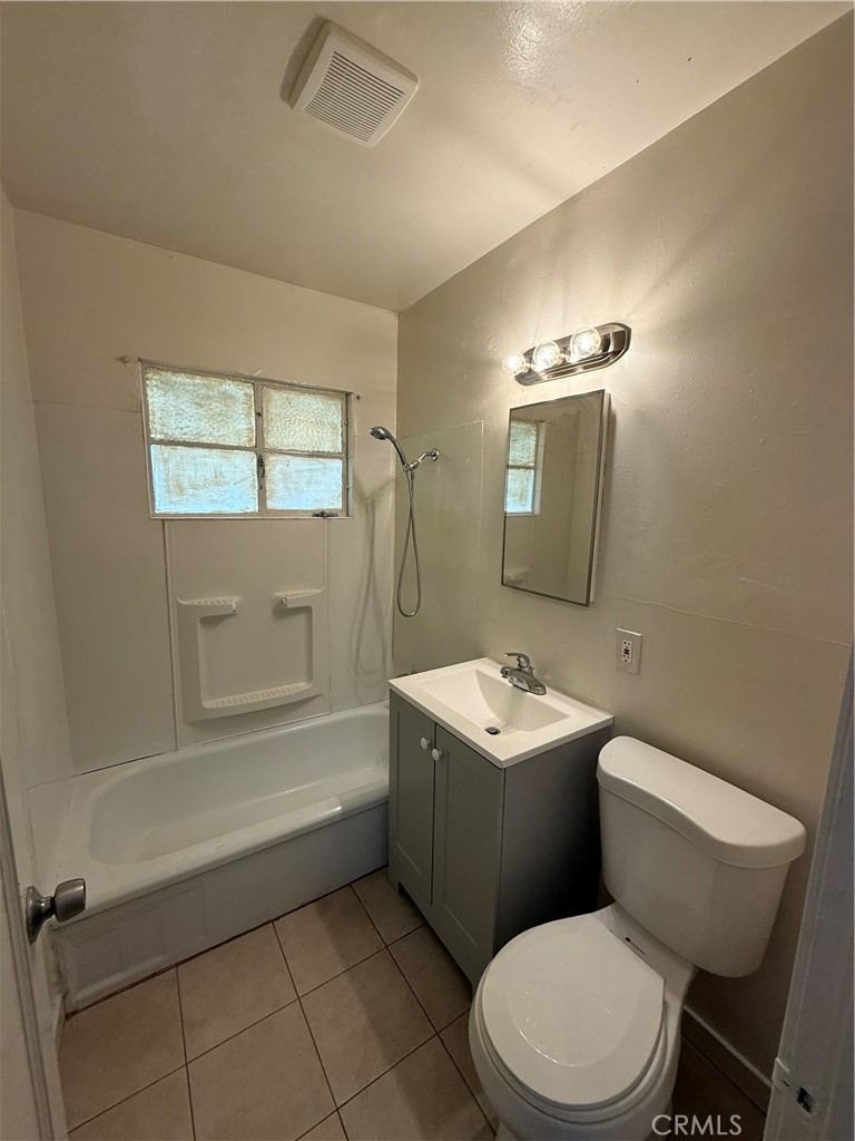 981 Barney Street Merced, CA 95340 - Photo 8 of 8 a bathroom with a toilet a sink a mirror and vanity
