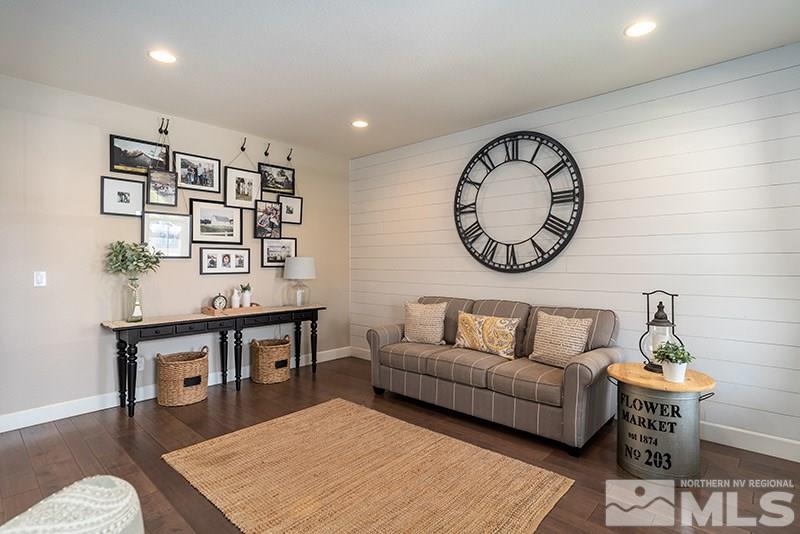 2785 Tobiano Drive Reno, NV 89521 - Photo 14 of 27 a living room with furniture a clock and a wall