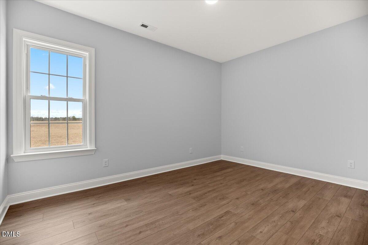 1300 Nick Coley Road Whitakers, NC 27891 - Photo 29 of 47 an empty room with wooden floor and windows