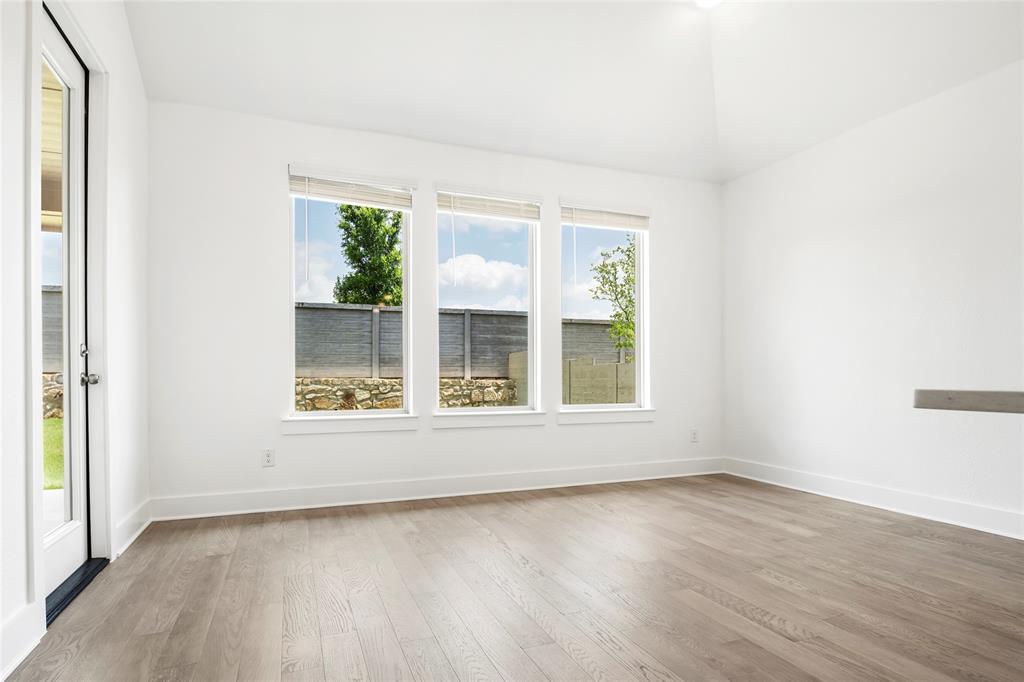 2900 Barbary Road McKinney, TX 75071 - Photo 14 of 36 Bright interior space featuring wood-finish flooring, white walls, and a vaulted ceiling