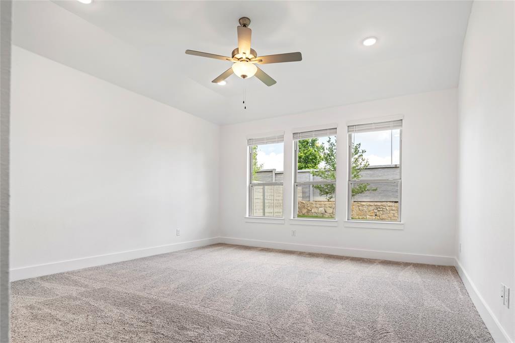 2900 Barbary Road McKinney, TX 75071 - Photo 21 of 36 Bright room featuring three large windows, recessed lighting, a ceiling fan, and plush carpeting