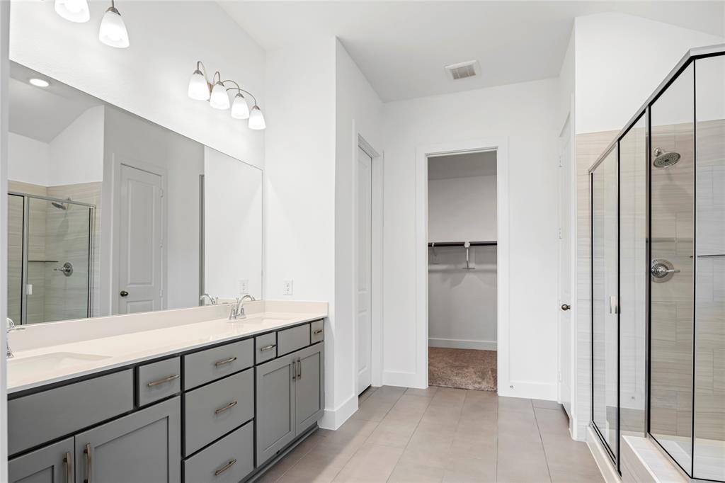 2900 Barbary Road McKinney, TX 75071 - Photo 24 of 36 Bathroom featuring a dual vanity with a light-colored countertop and gray cabinetry